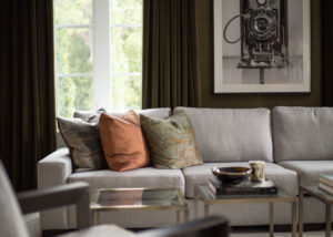 Image of modern living room detail featuring sofa with pillows.