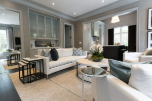 Additional image of modern living room featuring white sofa, chairs and coffee tables.
