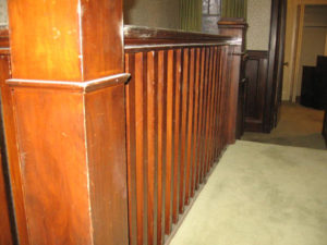 Image 2 of banister railing before refinishing